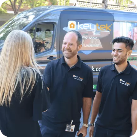 two keyetk locksmith shake hands with a customer with keytek van in the background